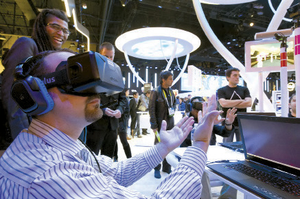 An attendee plays in a virtual volleyball game at the Intel booth during the CES-2015 in Las Vegas